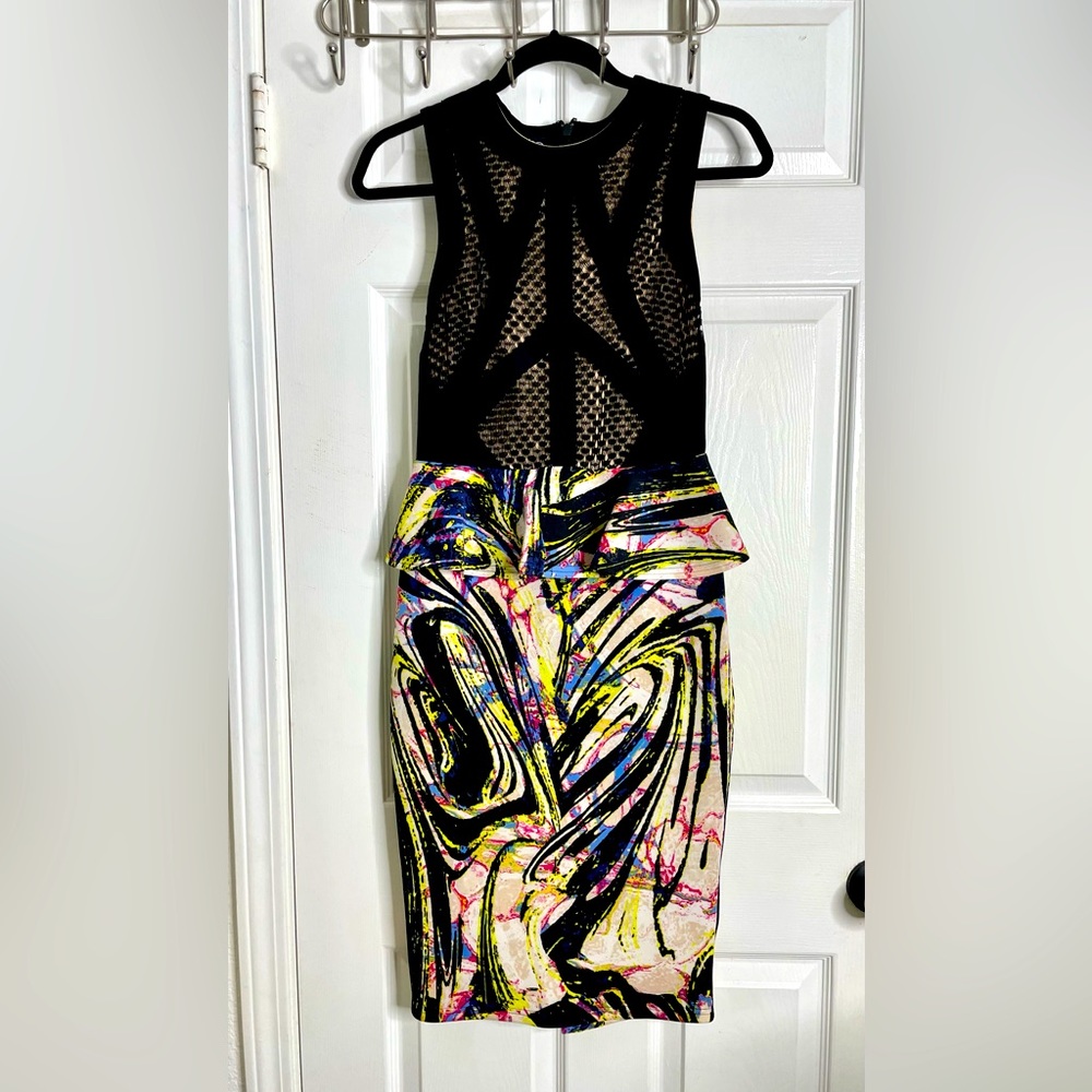Black peplum style of dress with abstract design.